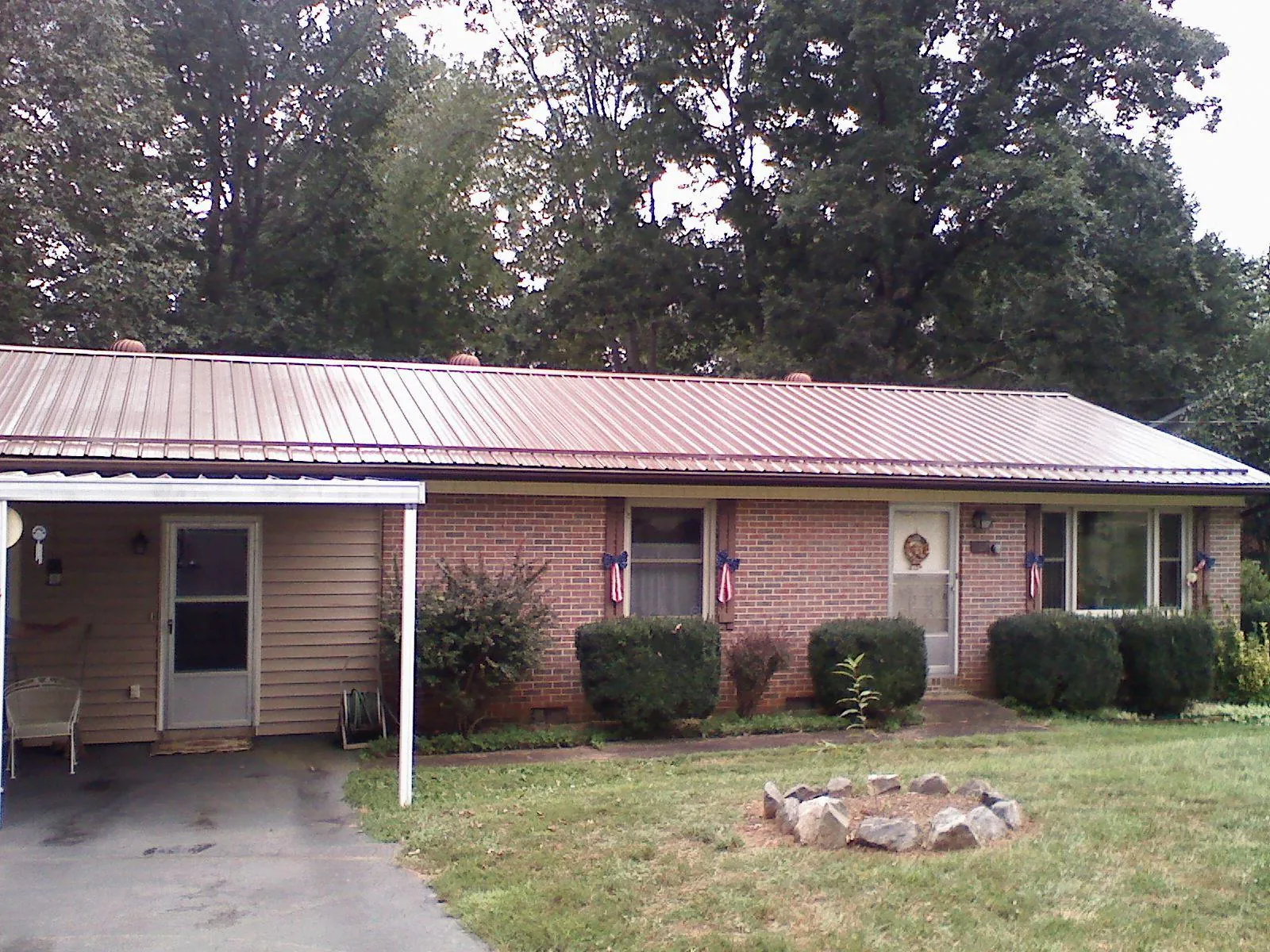 Bronze metal roof and carport on a brick ranch home — Roof Repair work by our crew in Beaverton